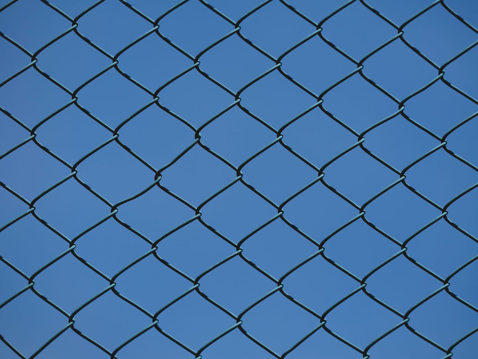 Chain link fence against a clear sky