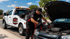 Towing Corona jump start service boosting a dead car battery to get a stranded vehicle running again.