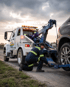 Towing Port Charlotte winch out and recovery service pulling an SUV from the roadside with a wheel lift tow truck.