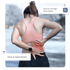Woman in athletic wear holding her lower back with pain showing red