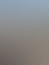 Luftaufnahme eines eingeruesteten weissen Wohnhauses mit MEB-Geruestbau-Banner an einer Strasse mit Tramgleisen.