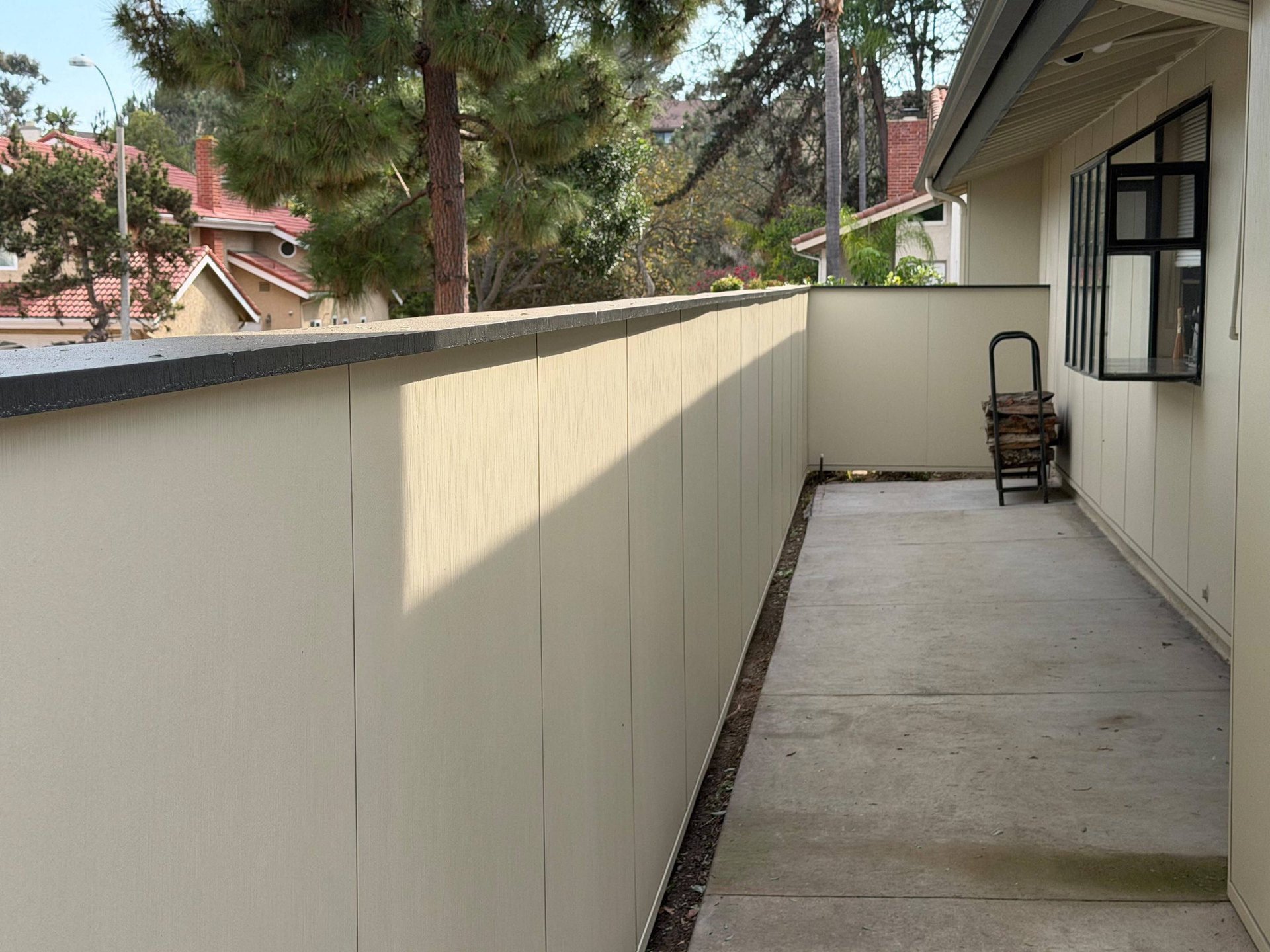 Side yard enclosed by a James Hardie Architectural Panel fence that matches the home's siding in San Diego