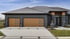 Modern house with two wood-look garage doors featuring horizontal windows, gray siding, and stone accents.