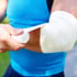 Person wraps elbow, treating a sports injury.
