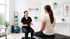 Physiotherapist in black scrubs at medical clinic with patient
