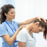 Chiropractor adjusting neck to alleviate tension and pain
