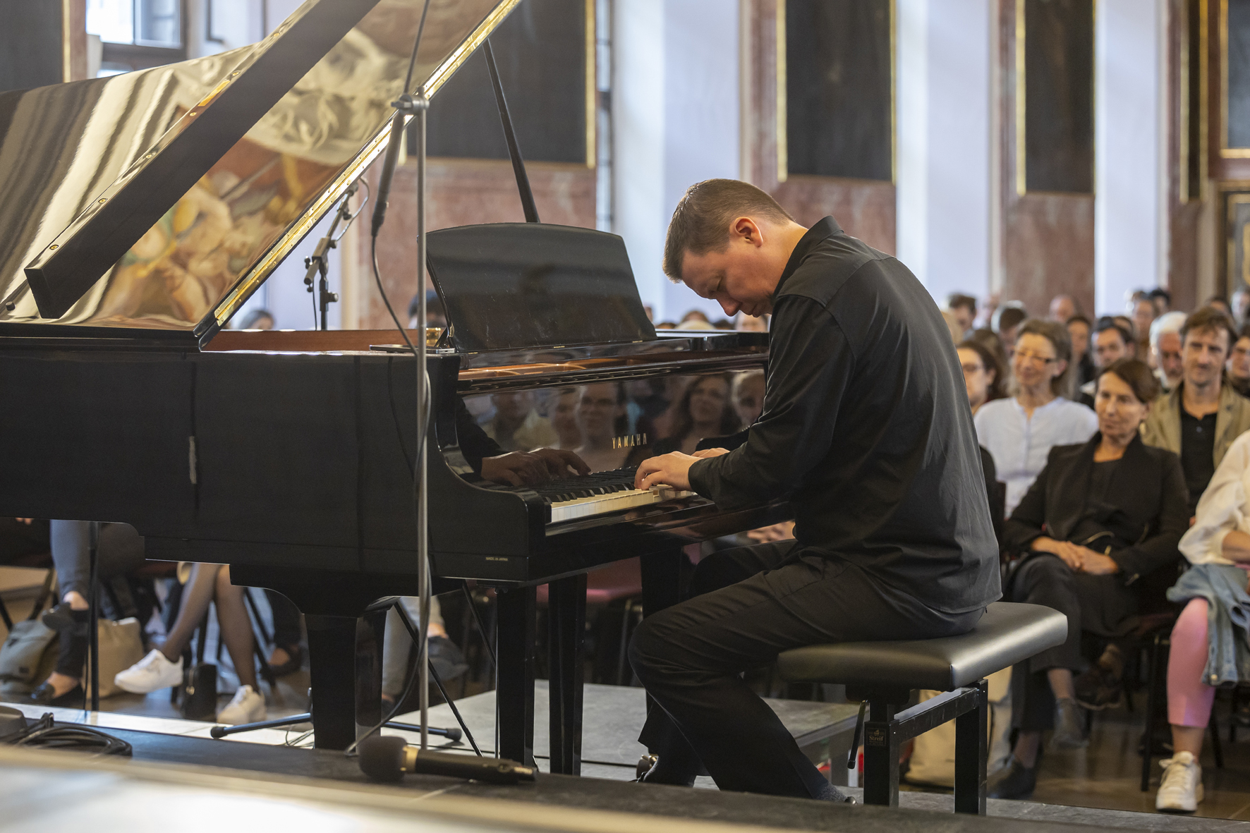 Ola Gjeilo at the piano in the Minoritensaal, Artist in Residence of Voices of Spirit 2024, Graz