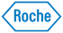 Blaues Roche-Logo in einem sechseckigen Rahmen auf dunkelgrünem Hintergrund.