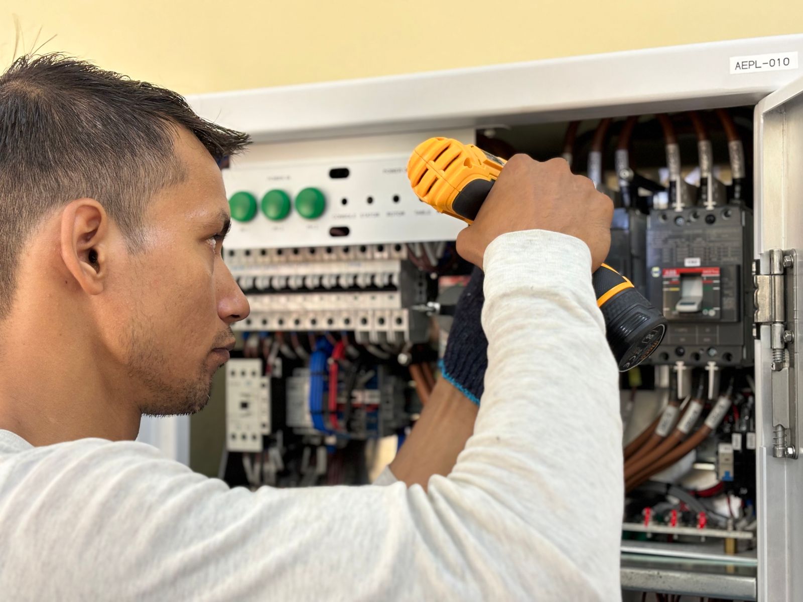 Licensed electrician working inside a residential electrical panel