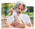 Man holding a tennis racket, clutching his elbow in pain