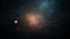 Dark background with a central orange glow and numerous small, scattered light particles.