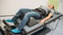 Man undergoes spinal decompression therapy on a medical bed.