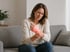 Woman experiencing wrist nerve pain and discomfort at rest