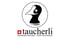 Taucherli Logo mit einem Vogelkopf im Kreis, Schweizer Flagge und Text „Handmade Chocolate Zurich Switzerland“.