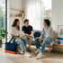 Three people sit together in a bright living room