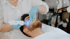 Ein Mann liegt und erhält eine Gesichtsbehandlung mit einem blauen Lichttherapiegerät und einem Schwamm.