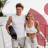 couple walks outdoors in activewear with yoga gear