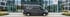 Grauer Ford Transit Custom Lieferwagen mit "Perfekt Glasreinigung" Logo und "Glasreinigung" Schriftzug unter grünen Bäumen.