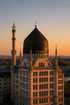 Das Yenidze-Gebäude in Dresden mit Kuppeldach und Minarett, beleuchtet von der untergehenden Sonne.