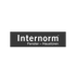 Internorm Logo: „Internorm Fenster – Haustüren“ in Grau auf dunklem Hintergrund.