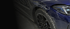 Nahaufnahme eines blauen Sportwagens mit Michelin-Reifen, schwarzen Alufelgen und LED-Scheinwerfer.