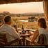 Couple enjoying sunset view at an African safari lodge terrace

Guests dining at a luxury safari lodge overlooking the savannah

Family on safari game drive observing wildlife in East Africa