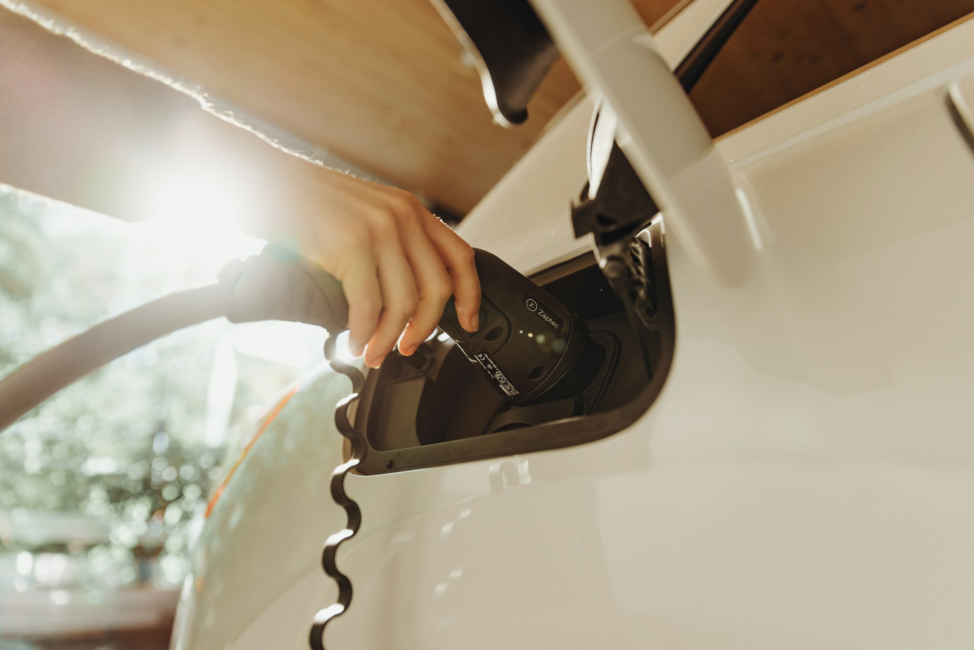 Charging connector being plugged into an electric vehicle