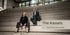 Zwei Personen sitzen auf einer Treppe, Text: "The Kassels", "The CFOs for your success".