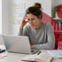 Woman with her hand on her forehead feling stressed due to hormonal imbalance