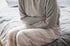 Person holding stomach to indicate discomfort