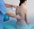 Professional examining a patient's back for sciatica.