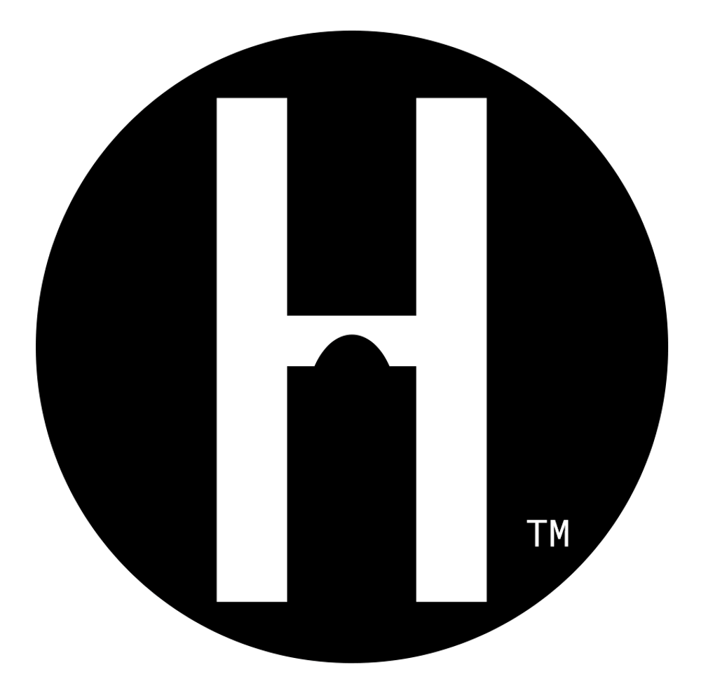 White letter H logo with a small arch cutout at its center, inside a black circle with a small "TM" mark.