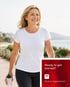 Happy woman walks outside, managing bladder leakage with modern treatments.