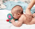 Chiropractor's hands massaging a baby with colic.