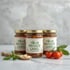 Three glass jars of tomato sauce with "YOUR PRIVATE LABEL" on labels, beside fresh basil, cherry tomatoes, and garlic.