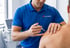 clinician administering shoulder injection therapy in Pain control clinic