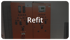 Zwei orangefarbene Schaltschränke mit Anzeigen und Bedienelementen sowie der weiße Textzug Refit im Vordergrund.