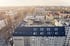 Blick von oben auf ein graues Gebäude mit mit fertig gestellter Aufstockung