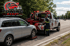 Towing Sandy tow truck operator loading a disabled SUV for roadside towing service in Sandy, Utah.