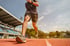 A male athlete running on a track after Sports chiropractic treatment.