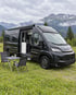 Adria Twin Edition 640 SGX auf einer Almwiese mit Tisch und Stühlen