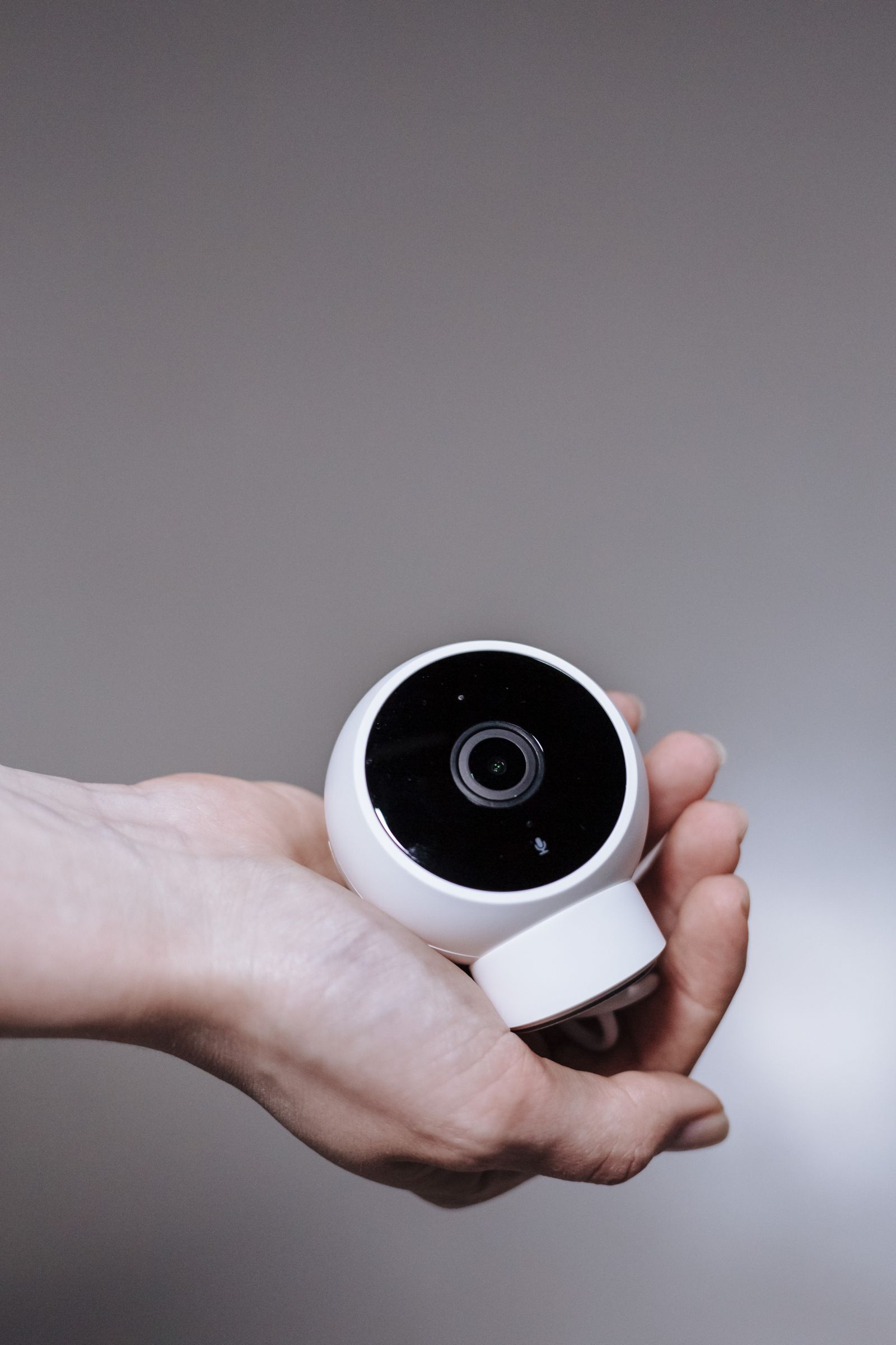 Smart home security device held in hand during setup