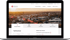 MacBook zeigt die Website der Stadtwerke Osnabrück mit einer Stadtansicht bei Sonnenuntergang und Navigation.