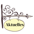 Ein schmiedeeisernes Schild mit der Aufschrift "Aktuelles" auf einem gelben Oval.