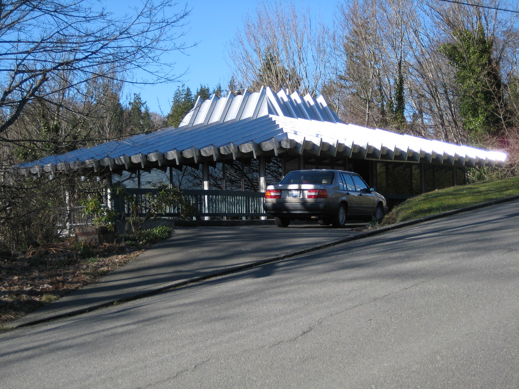 Standing seam metal roof panels running the length of a low-pitch roof