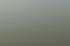 Moderne weiße Mehrfamilienhäuser mit Balkonen und Glasgeländern neben einer Grünanlage bei sonnigem Wetter.