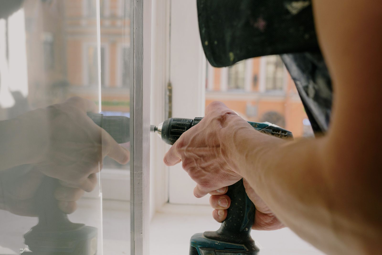Crew member fitting a replacement window unit
