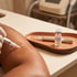 A gloved hand uses a microneedling pen on skin next to a vial labeled Exosome Rejuvenation Serum.