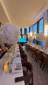 Elegant long dining table with cloud decorations at the Moroccanoil PR launch event