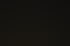 Eine eingeschaltete Tischlampe neben einem Bett